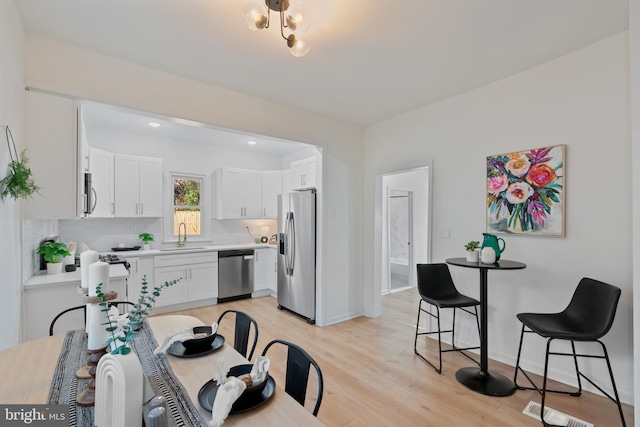 dining space featuring light hardwood / wood-style floors and sink