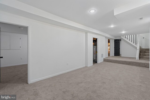 basement featuring carpet floors and water heater