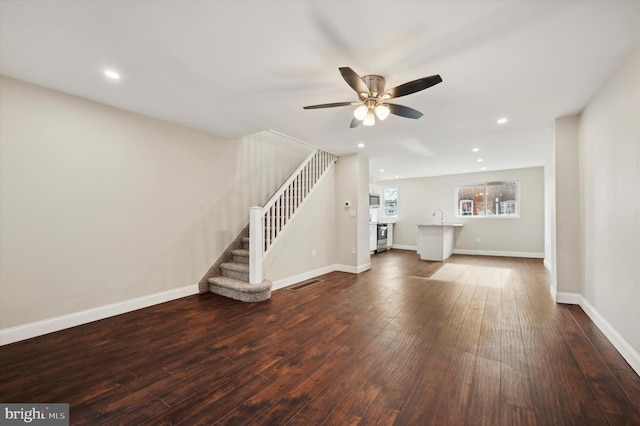 unfurnished living room with hardwood / wood-style floors and ceiling fan