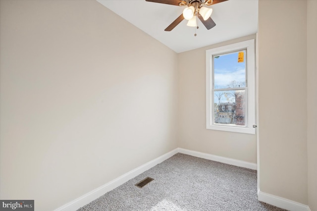 carpeted empty room with ceiling fan and vaulted ceiling