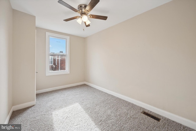 carpeted spare room with ceiling fan