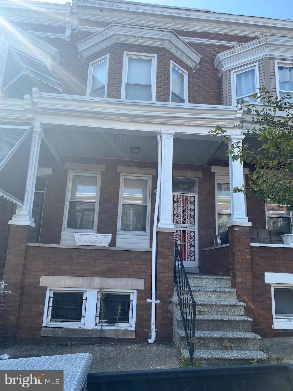 1808 N Bentalou St, Baltimore, MD 21216 - view of front facade featuring covered porch and brick siding