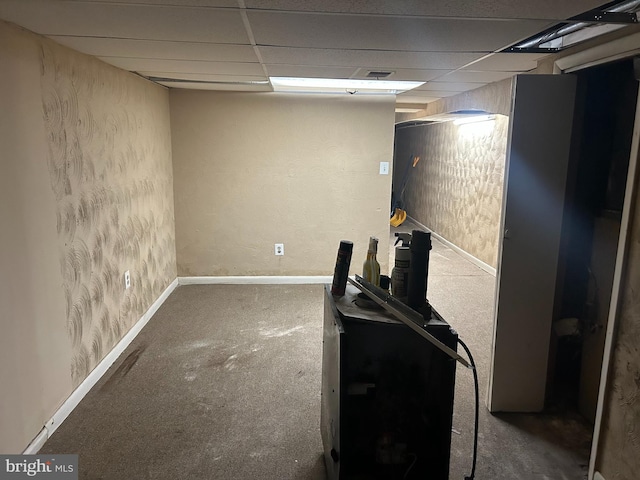 basement with a drop ceiling and carpet floors