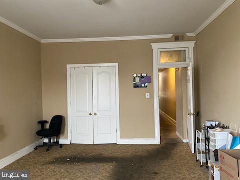 bedroom featuring a closet and crown molding