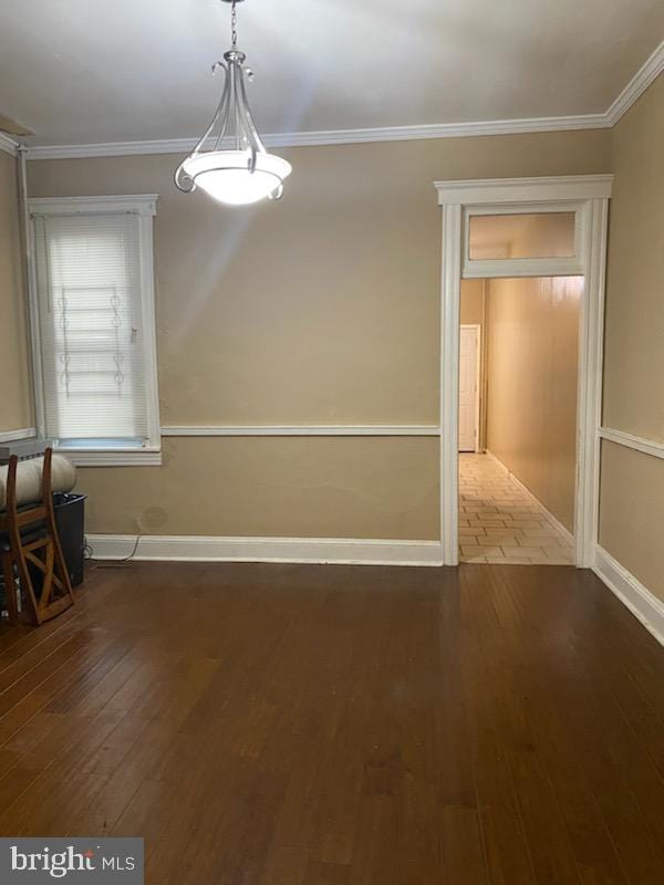 unfurnished dining area featuring dark hardwood / wood-style flooring and crown molding