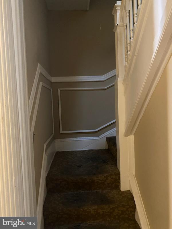 staircase with wood-type flooring