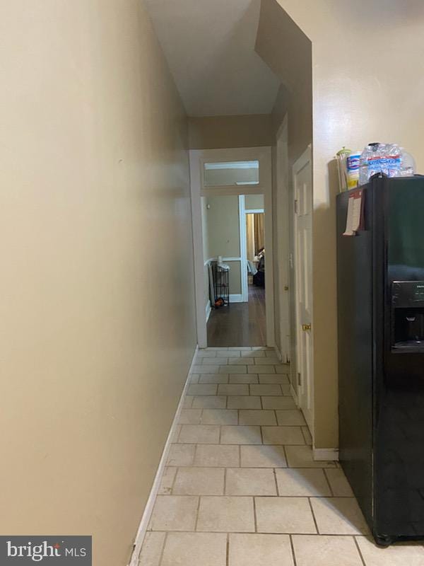 corridor featuring light tile patterned flooring