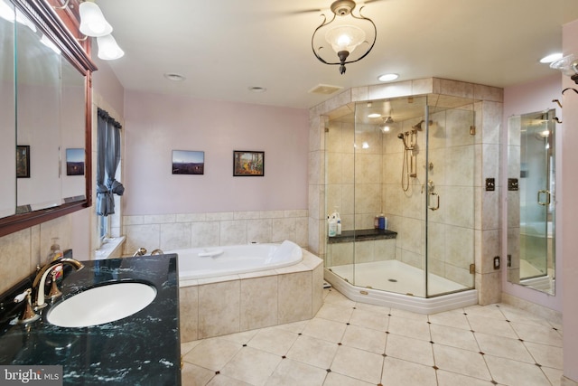 bathroom with shower with separate bathtub and vanity