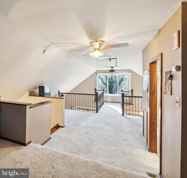 bonus room with ceiling fan, light carpet, and lofted ceiling