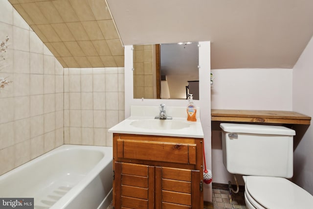 bathroom with a tub, vanity, vaulted ceiling, and toilet