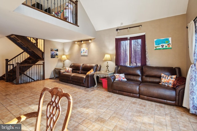 living room with light tile patterned floors and high vaulted ceiling