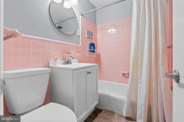 full bathroom featuring shower / bath combo, vanity, toilet, and tile walls