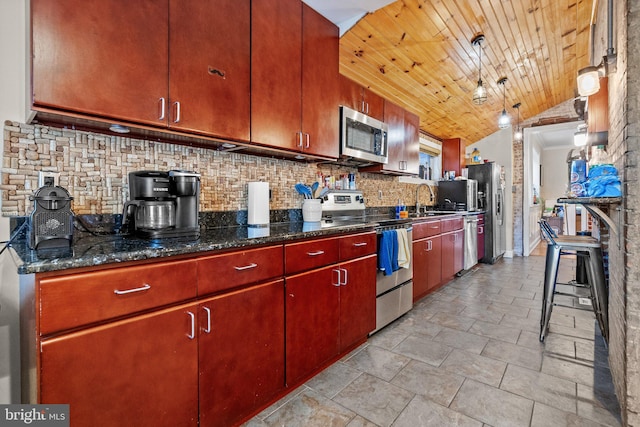 kitchen with backsplash, dark stone counters, sink, vaulted ceiling, and stainless steel appliances