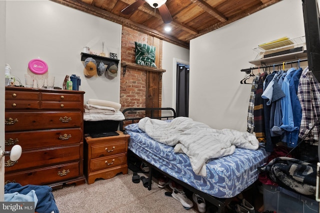 bedroom with ceiling fan, light colored carpet, and wooden ceiling