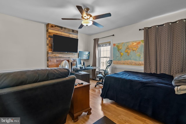 bedroom with light hardwood / wood-style floors and ceiling fan