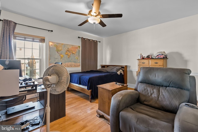 bedroom with ceiling fan and light hardwood / wood-style flooring