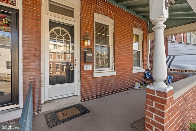 view of exterior entry with a porch