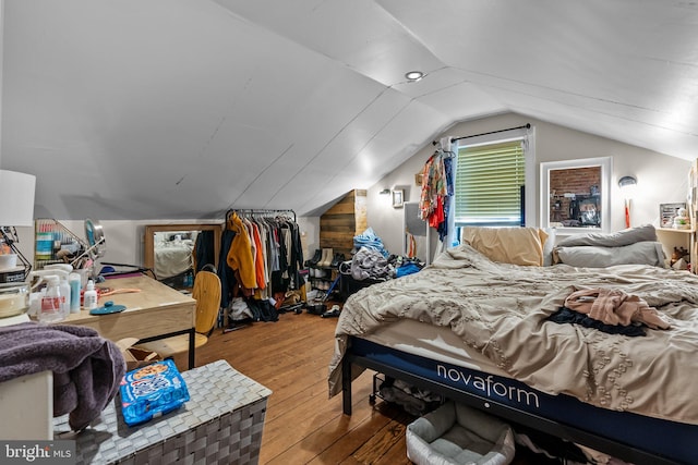 bedroom featuring hardwood / wood-style floors and lofted ceiling