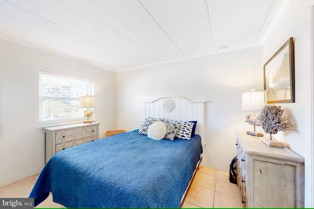 bedroom with light tile patterned floors