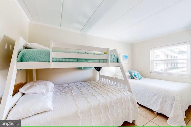 tiled bedroom featuring crown molding