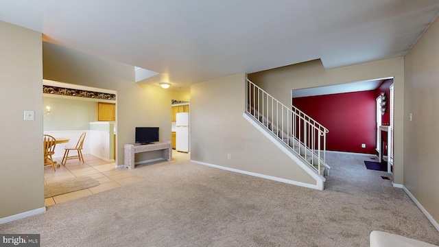 unfurnished living room featuring light colored carpet