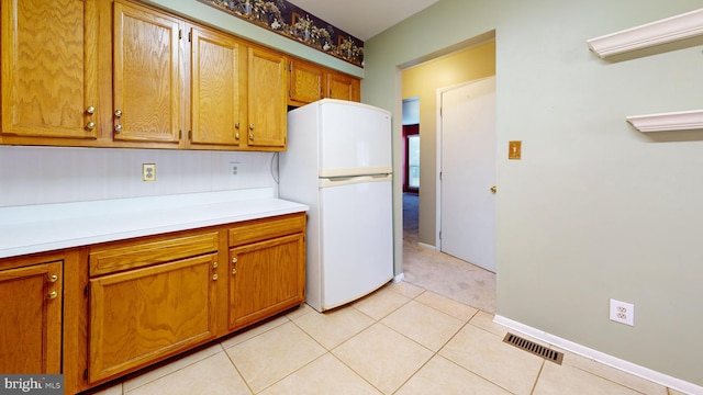 kitchen featuring white fridge and light tile patterned floors