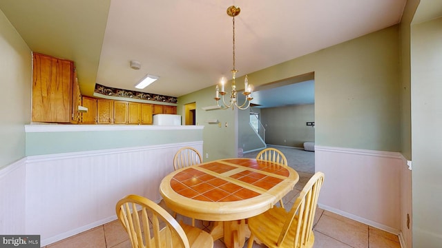 dining room with light tile patterned flooring and a chandelier