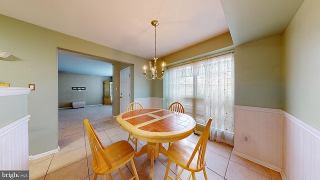 dining area featuring an inviting chandelier and light tile patterned floors