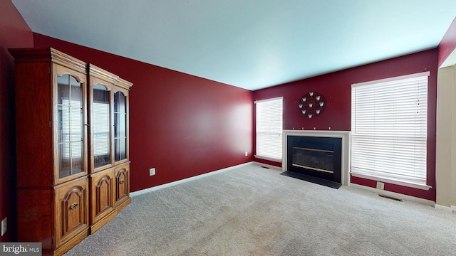 unfurnished living room with light carpet