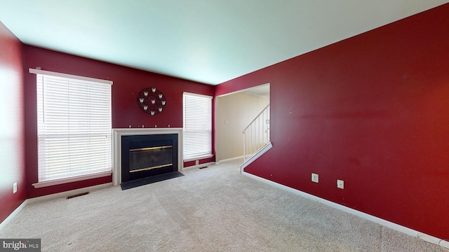 unfurnished living room with light carpet