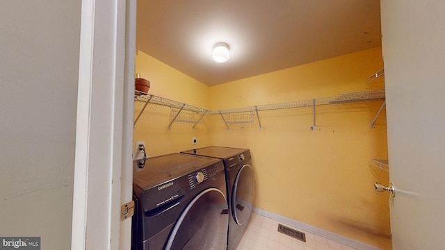 clothes washing area featuring washing machine and clothes dryer