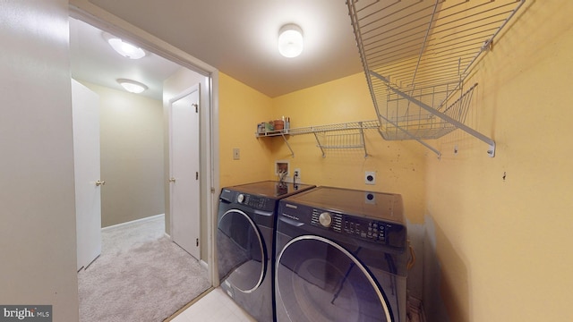 washroom with washer and clothes dryer and light carpet