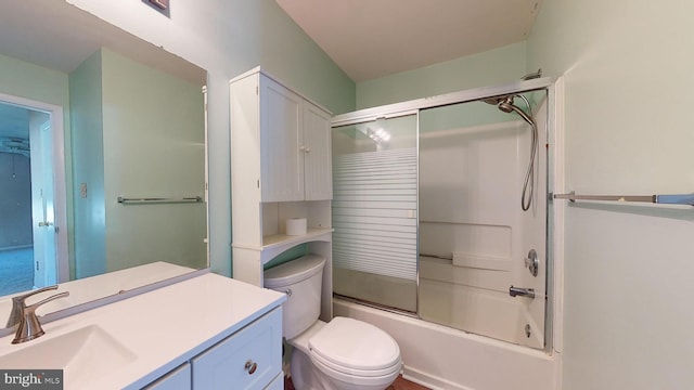 full bathroom with enclosed tub / shower combo, vanity, and toilet