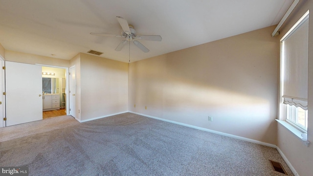 spare room featuring light carpet and ceiling fan