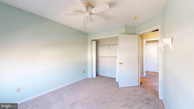 unfurnished bedroom with ceiling fan, light colored carpet, and a closet