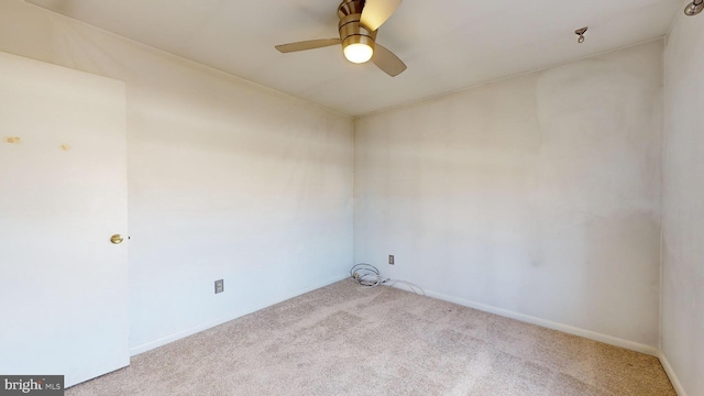 empty room with ceiling fan and light carpet