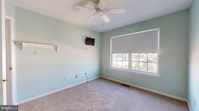 empty room with ceiling fan and light colored carpet