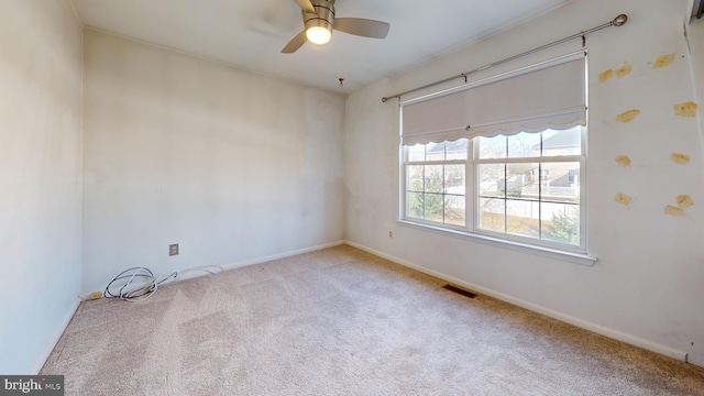 spare room featuring ceiling fan and light colored carpet