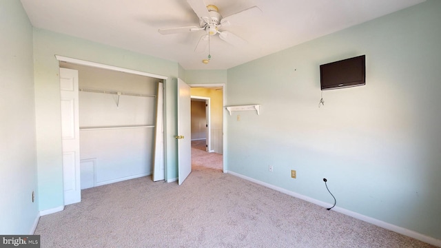 unfurnished bedroom with a closet, light carpet, and ceiling fan