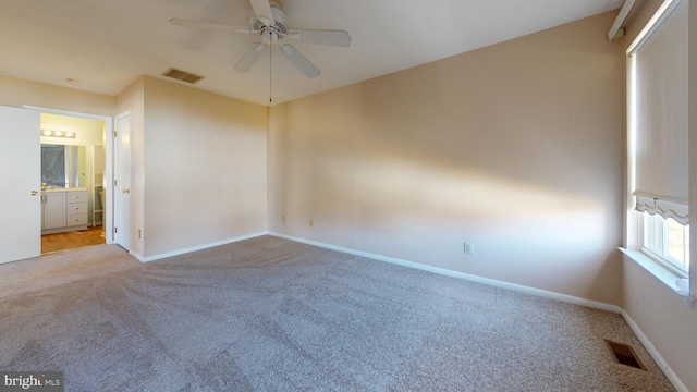 unfurnished room featuring light colored carpet and ceiling fan