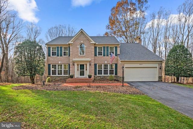 view of front of home with a front lawn and a garage