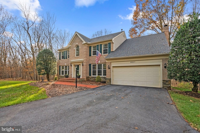 view of front of property featuring a front lawn and a garage