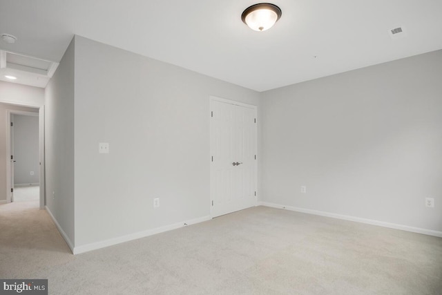 unfurnished room with light colored carpet