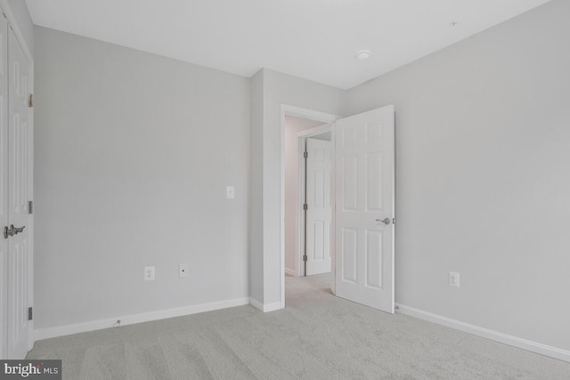 unfurnished bedroom featuring light colored carpet