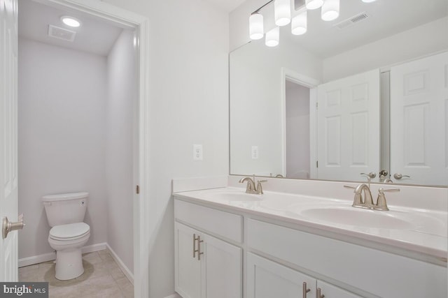 bathroom with tile patterned floors, vanity, and toilet