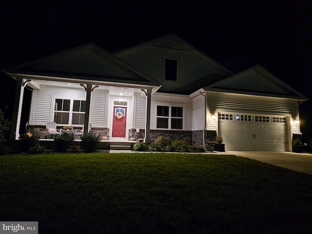 craftsman-style house with a garage and a yard