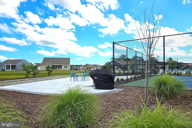 view of pool with tennis court and area for grilling