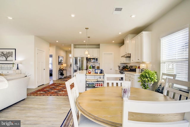 dining room with light wood-type flooring