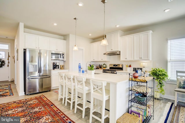 kitchen featuring sink, plenty of natural light, white cabinets, and appliances with stainless steel finishes