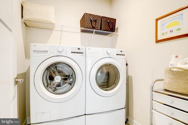 clothes washing area with independent washer and dryer